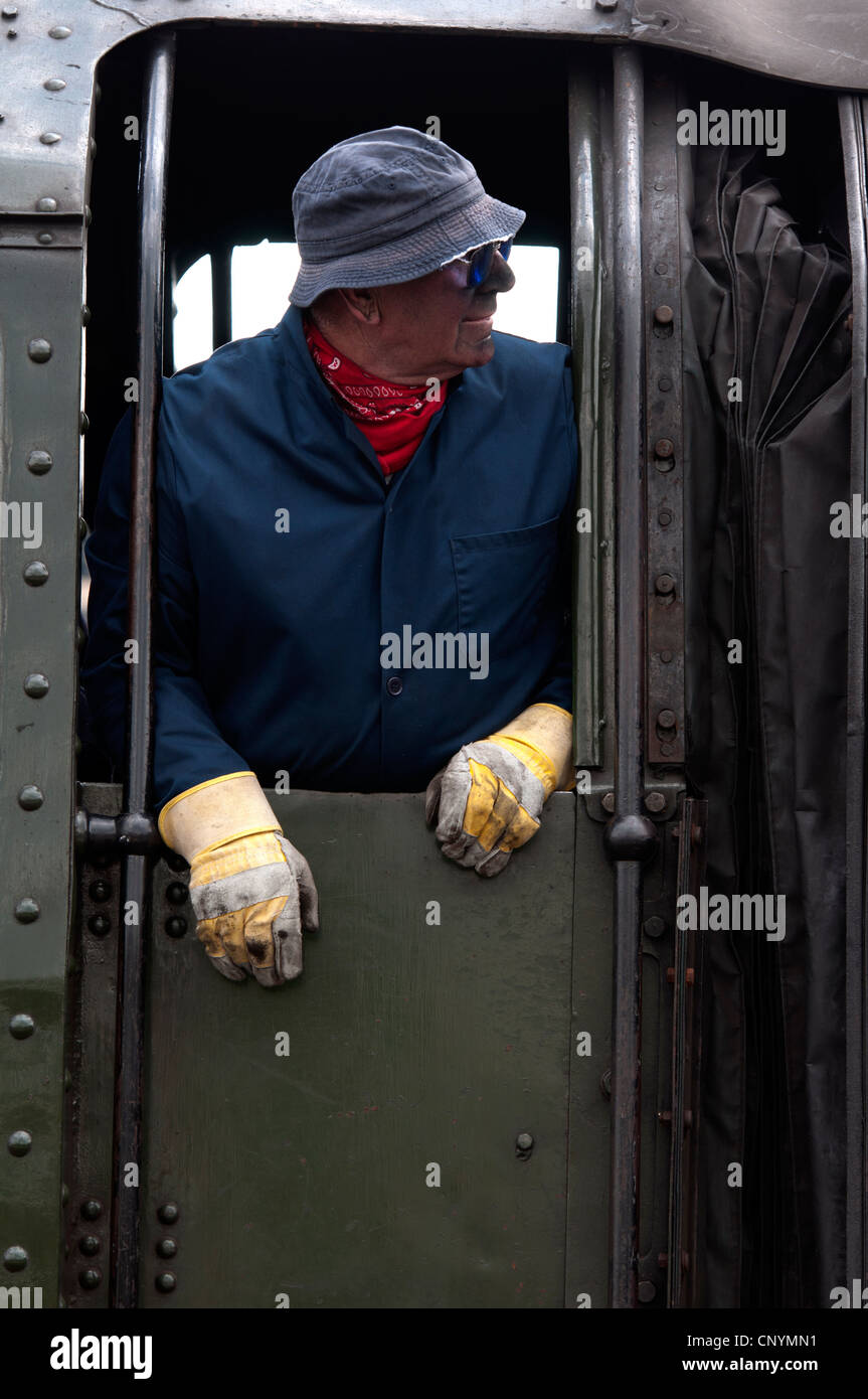 Train crew member on footplate of Britannia class steam locomotive No. 70013 'Oliver Cromwell' Stock Photo