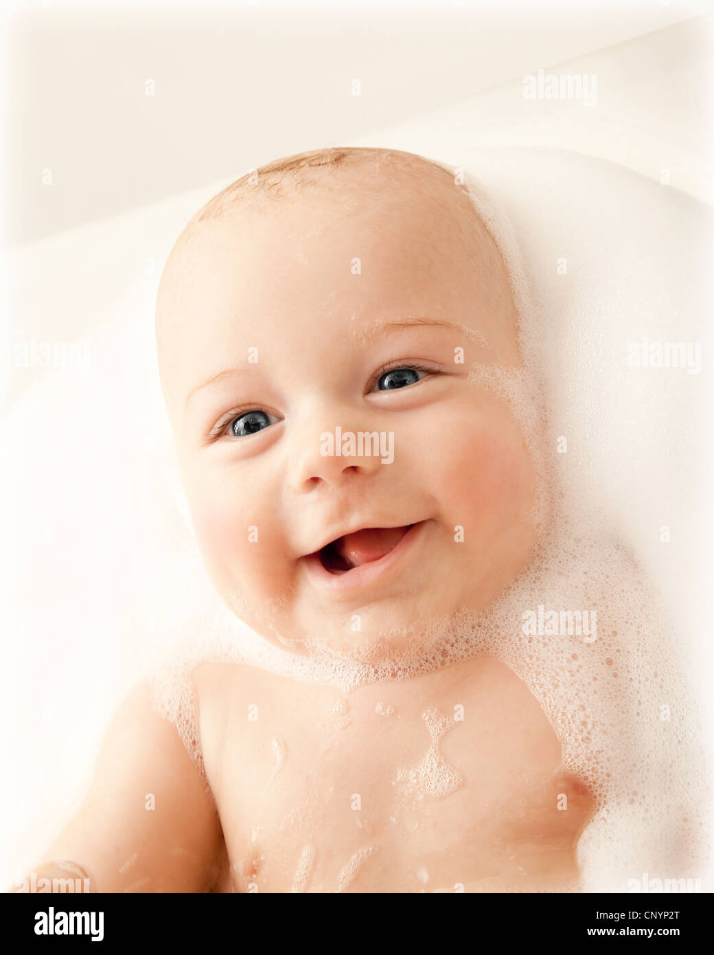 Little baby taking bath, closeup portrait of smiling boy, health care