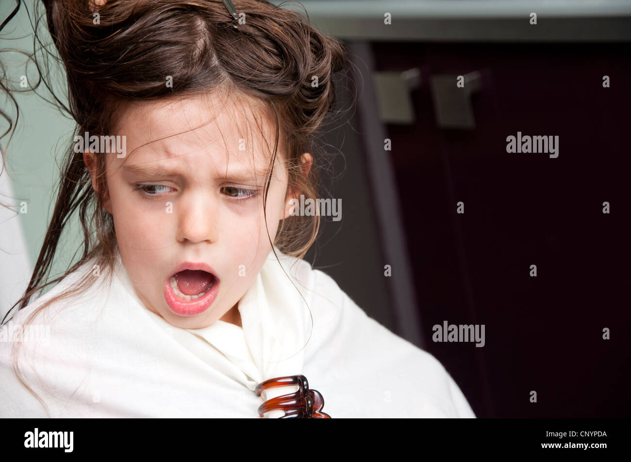 Five year old girl having hair cut protests as tangled hair gets pulled Stock Photo Alamy