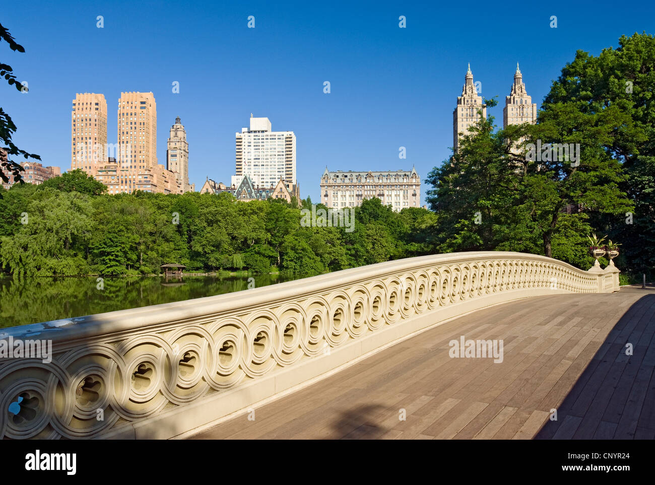 Central Park Bow Bridge, New York City and the Central Park West Skyline, New York Stock Photo