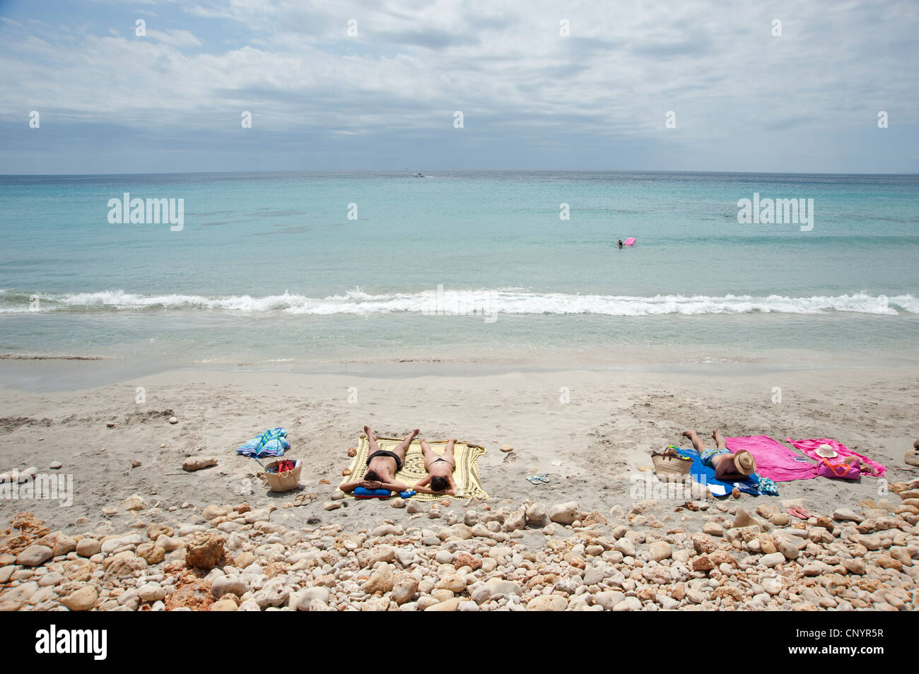 Sunbathers on Binigaus beach Menorca Spain Stock Photo