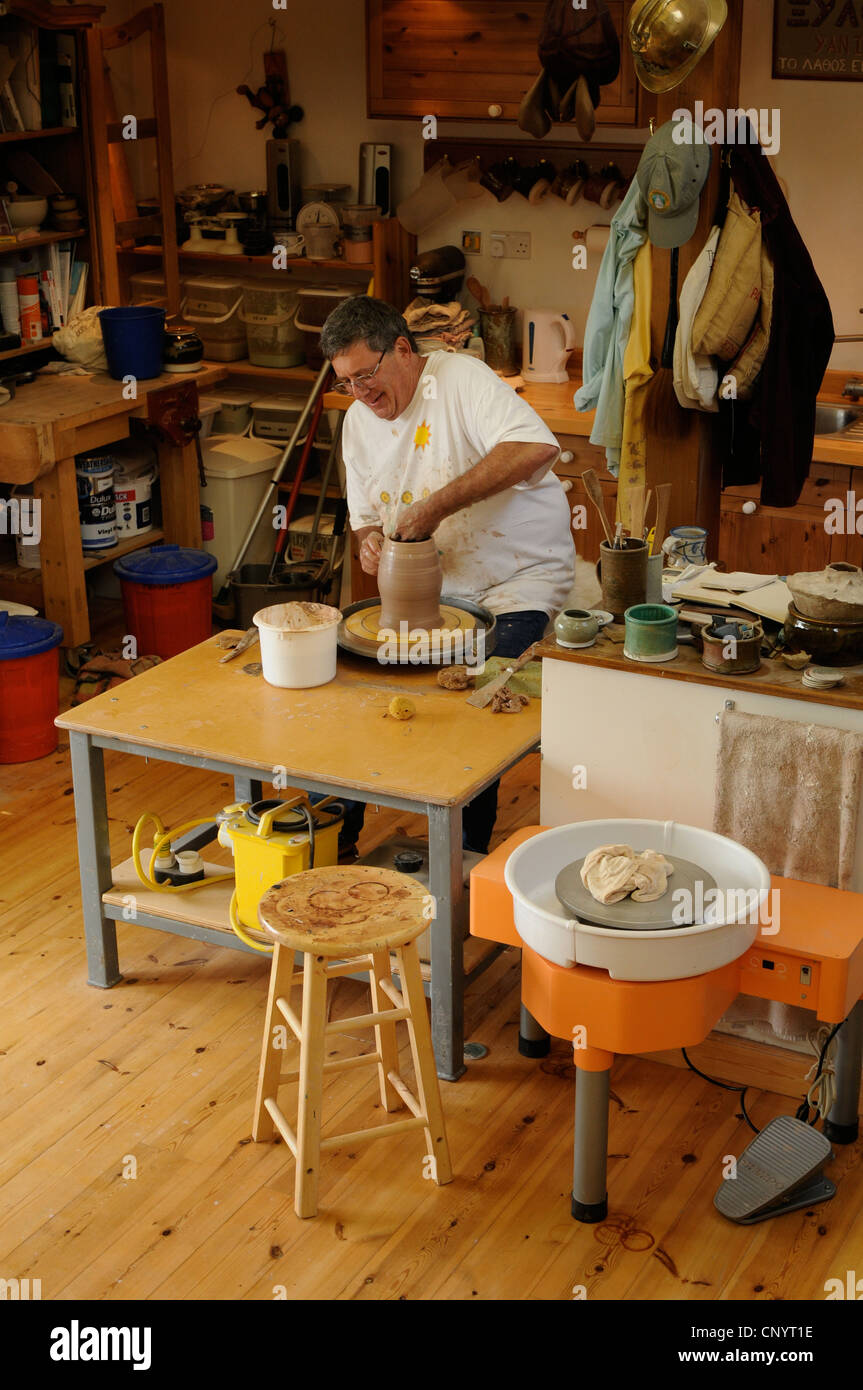 Potter at his wheel and kiln in his Vidlin Shetland Scotland