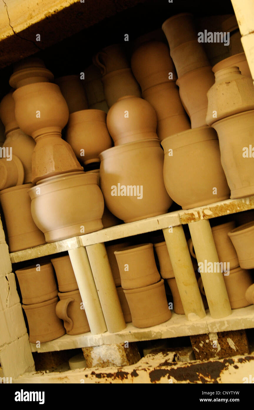 Potter at his wheel and kiln in his Vidlin Shetland Scotland