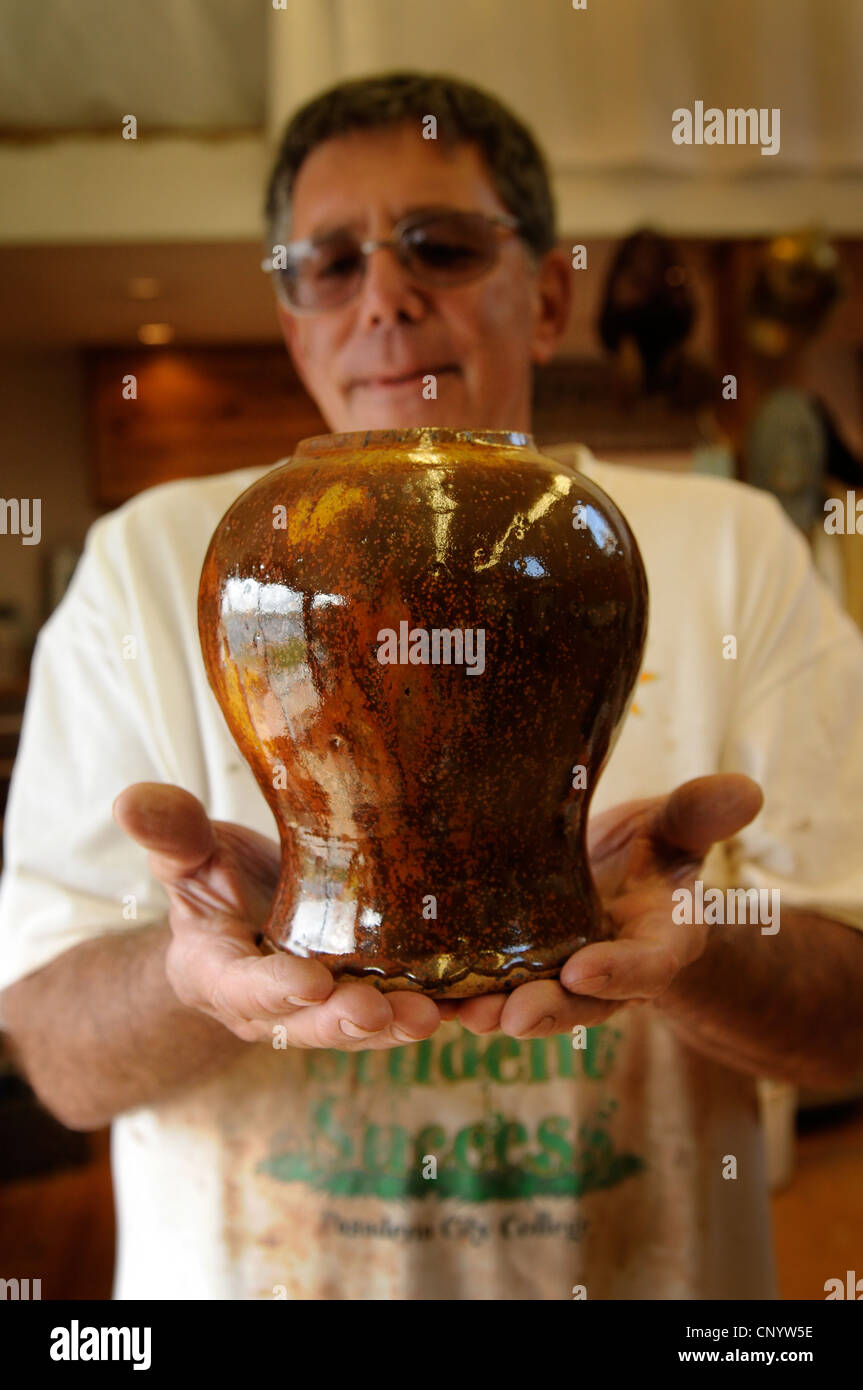 Potter at his wheel and kiln in his Vidlin Shetland Scotland