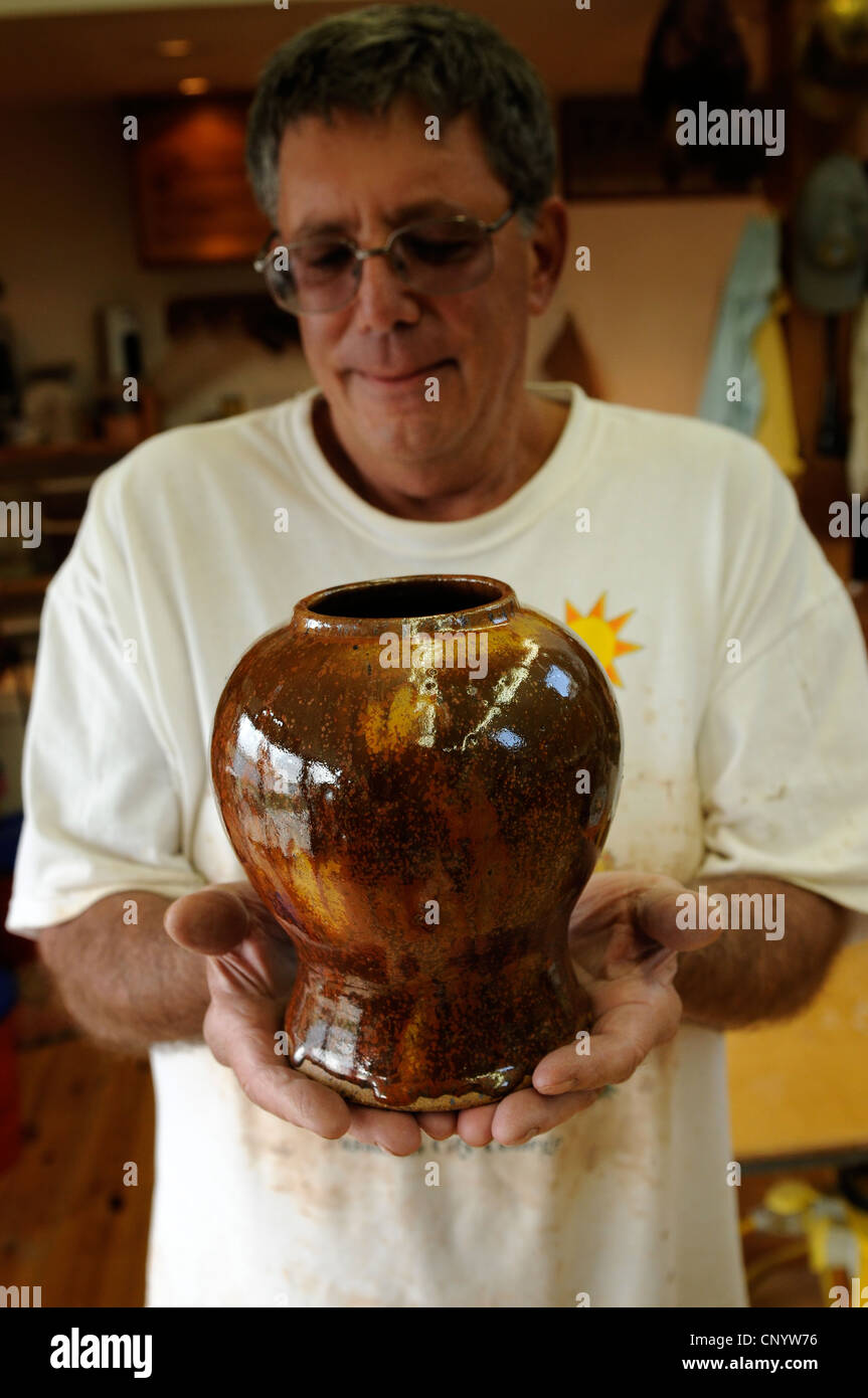 Potter at his wheel and kiln in his Vidlin Shetland Scotland