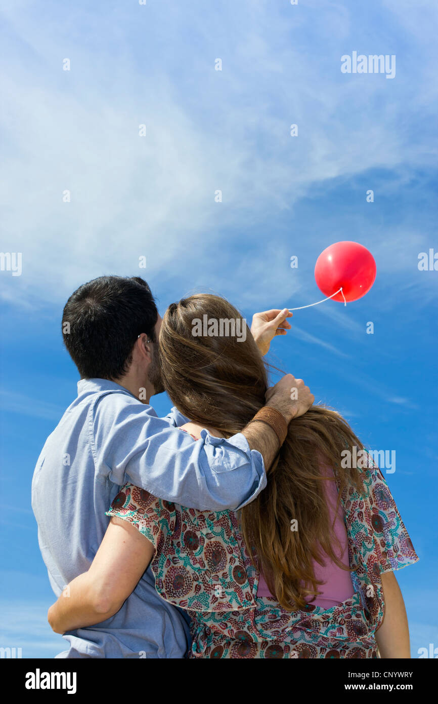 Young couple flying red balloon Stock Photo