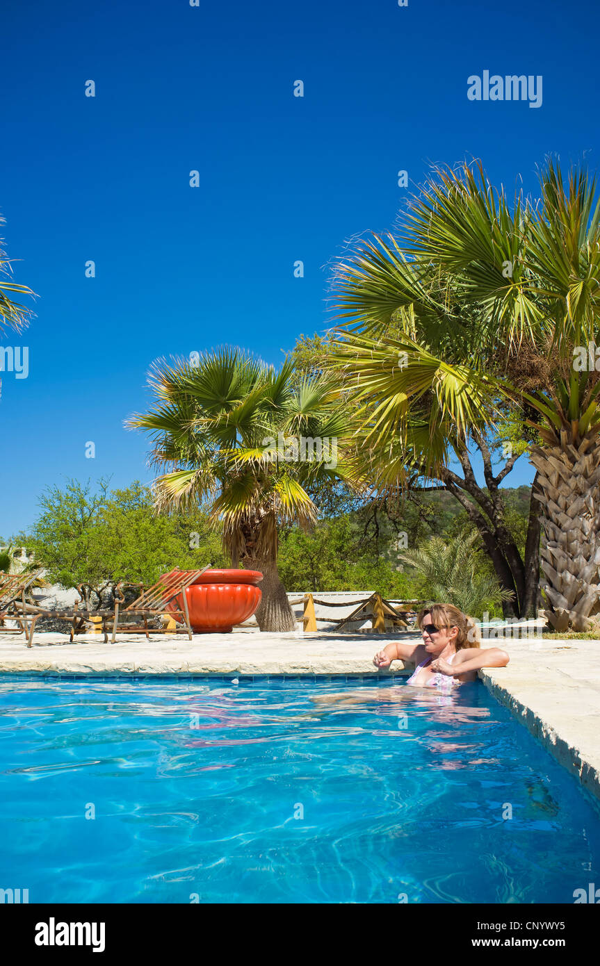 Woman relaxing in swimming pool Stock Photo - Alamy