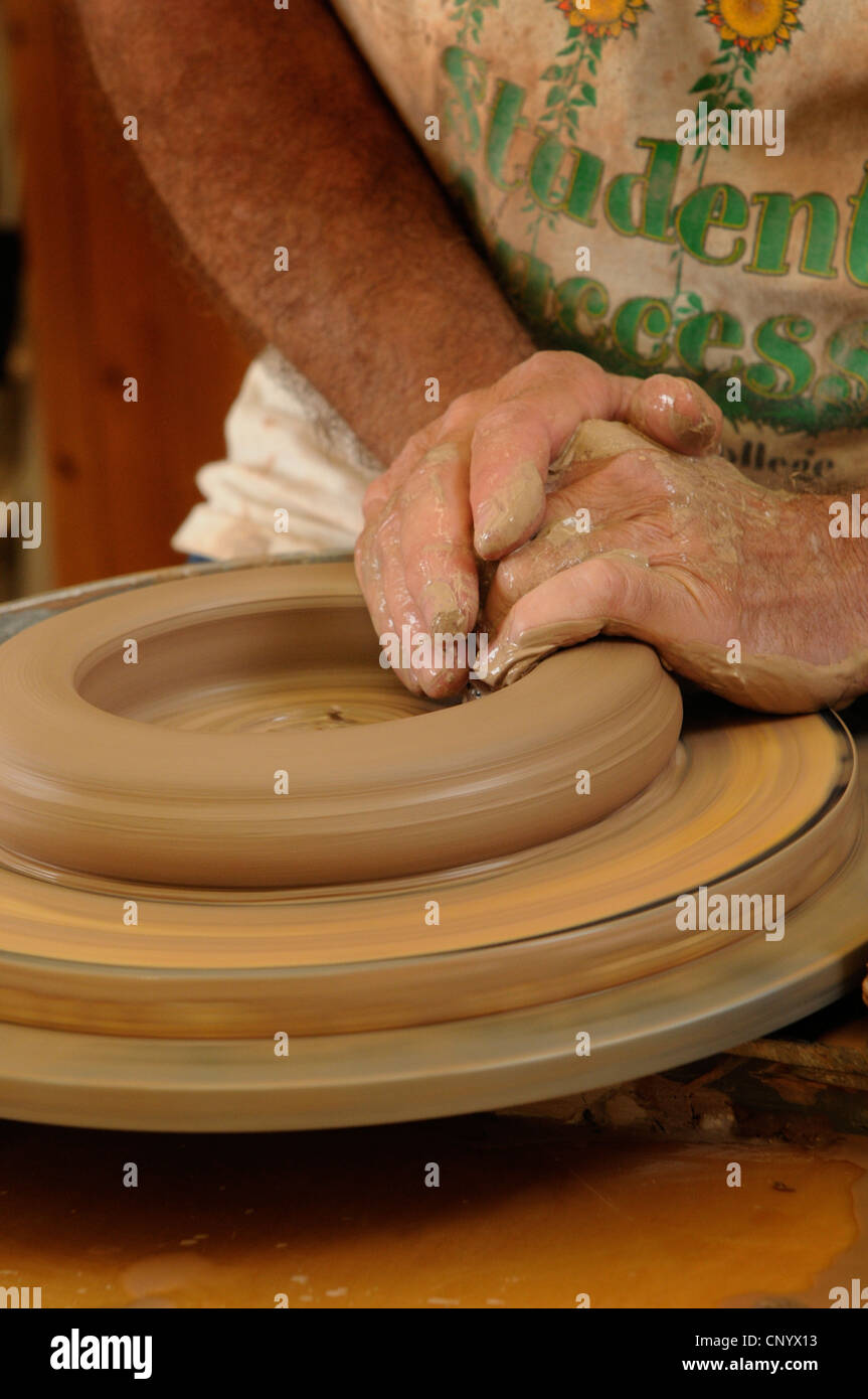 Potter at his wheel and kiln in his Vidlin Shetland Scotland