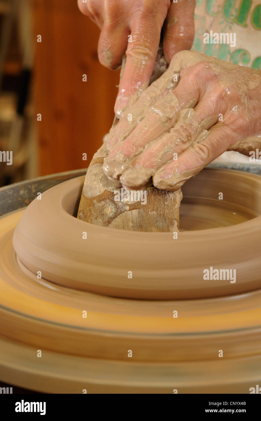 Potter at his wheel and kiln in his Vidlin Shetland Scotland