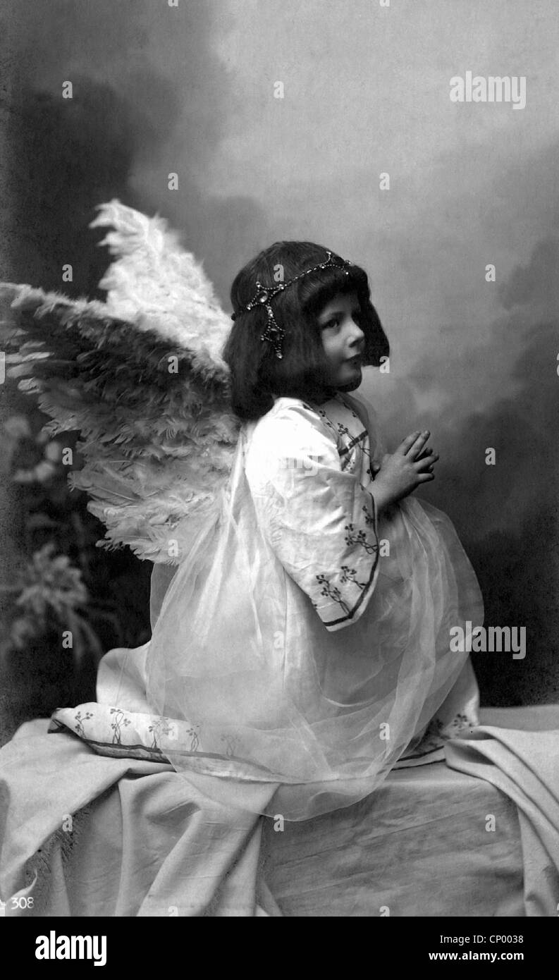 Christmas, child as angel, kneeling and praying, postcard, early 20th century, wings, kitsch, kids, kid, children, girl, historic, historical, 1900s, 1910s, Additional-Rights-Clearences-Not Available Stock Photo