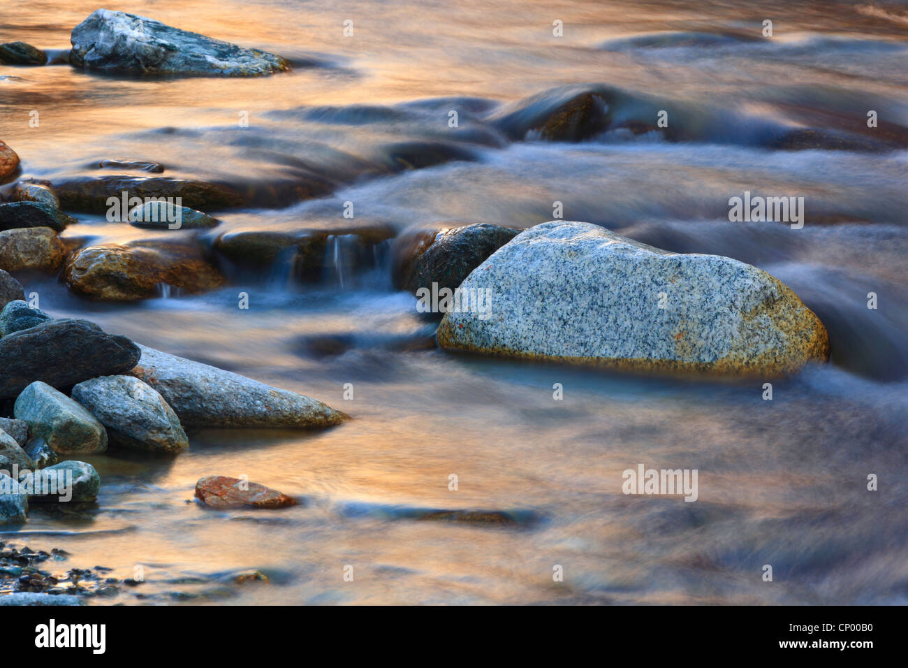 bolders and the glow of the evening sky in the riverbed of the Lonza in the Loetschental, Switzerland, Valais Stock Photo