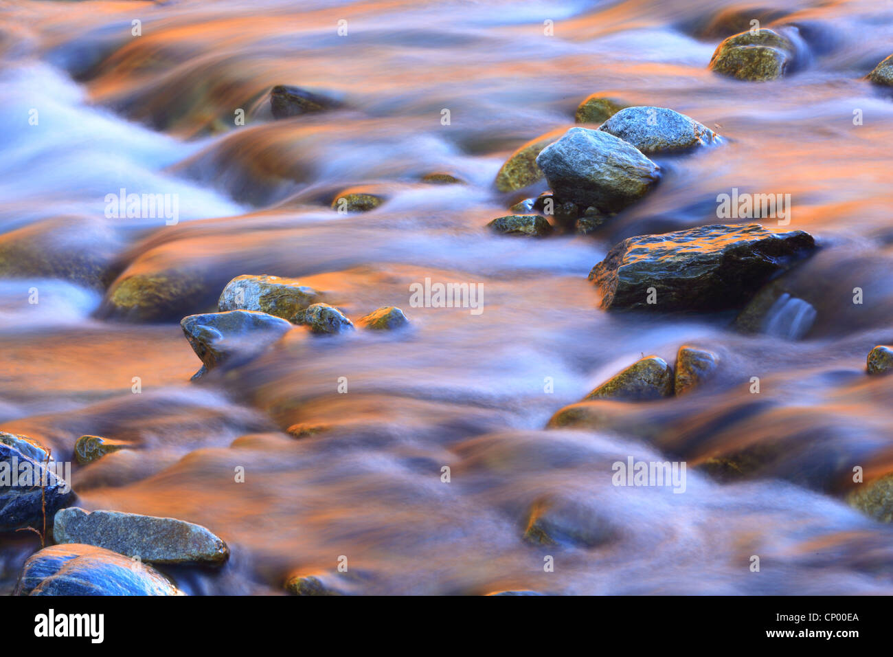 stones and reflexions of the afterglow in the riverbed of the Lonza in the Loetschental, Switzerland, Valais Stock Photo