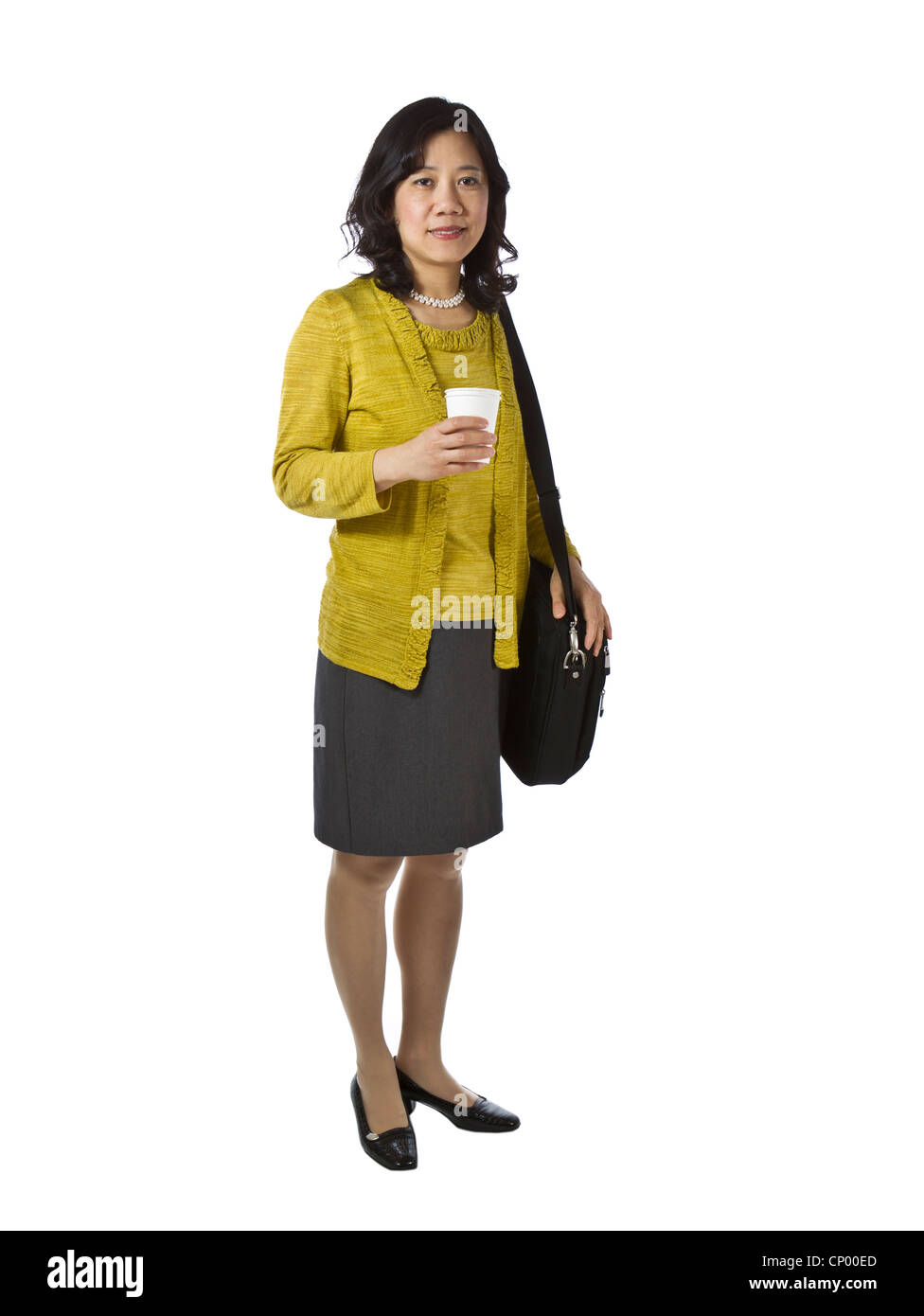 Asian women with paper coffee cup and laptop case dressed business causal on white background Stock Photo