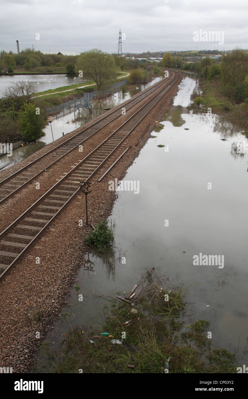 railway tracks cutting through flood water [flood warning] Stock Photo