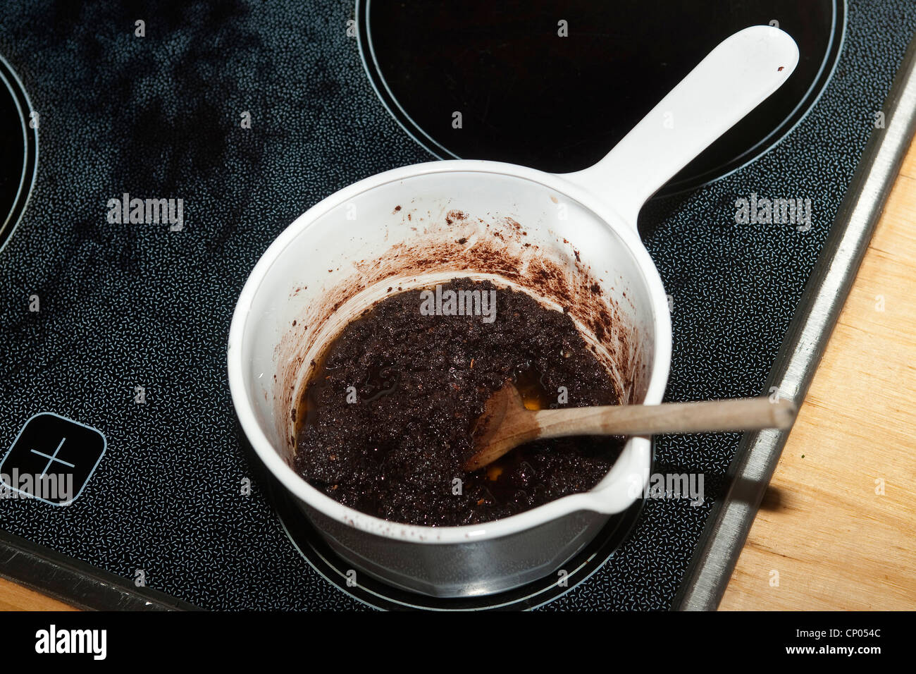 Common hazel (Corylus avellana), self-collected and milled hazelnuts, cocoa powder, butter and sugar stirred in a pot on the stove for making chocolate spread, Germany Stock Photo