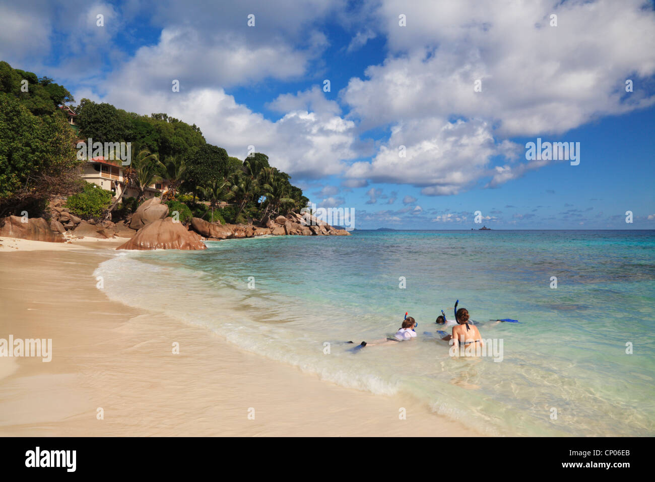 Family with snorkels, dive masks and fins enjoying the tropical beauty