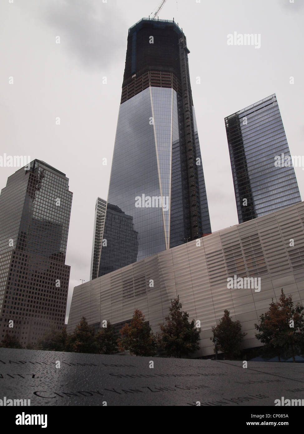 Partially built 1 WTC Freedom Tower in background of 9/11 Memorial in New York City, October 12, 2011, © Katharine Andriotis Stock Photo