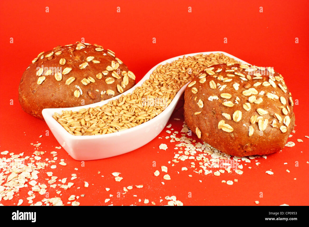 Two pastries with oat seeds on red background Stock Photo