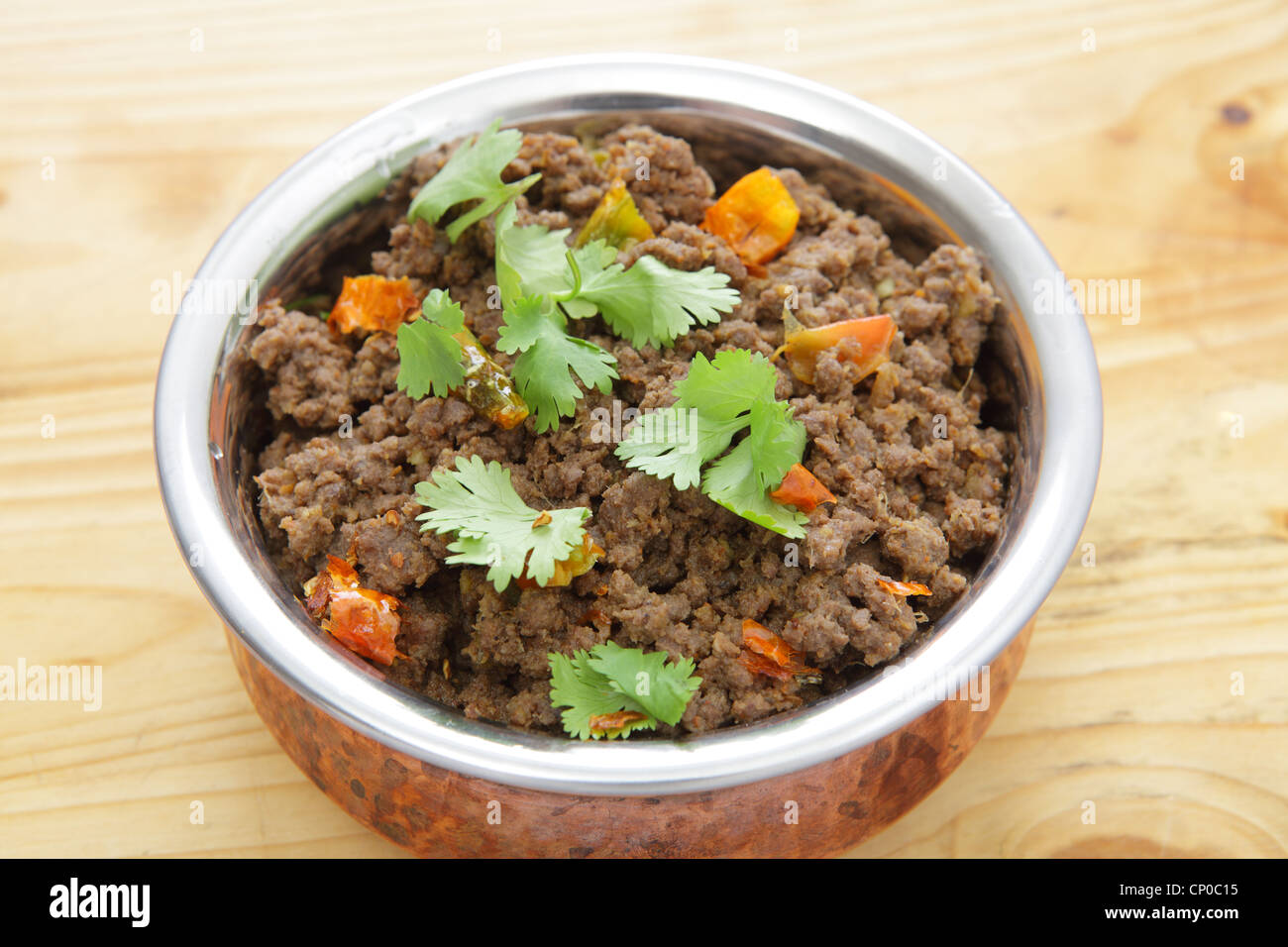A minced beef or keema curry in a serving bowl, garnished with