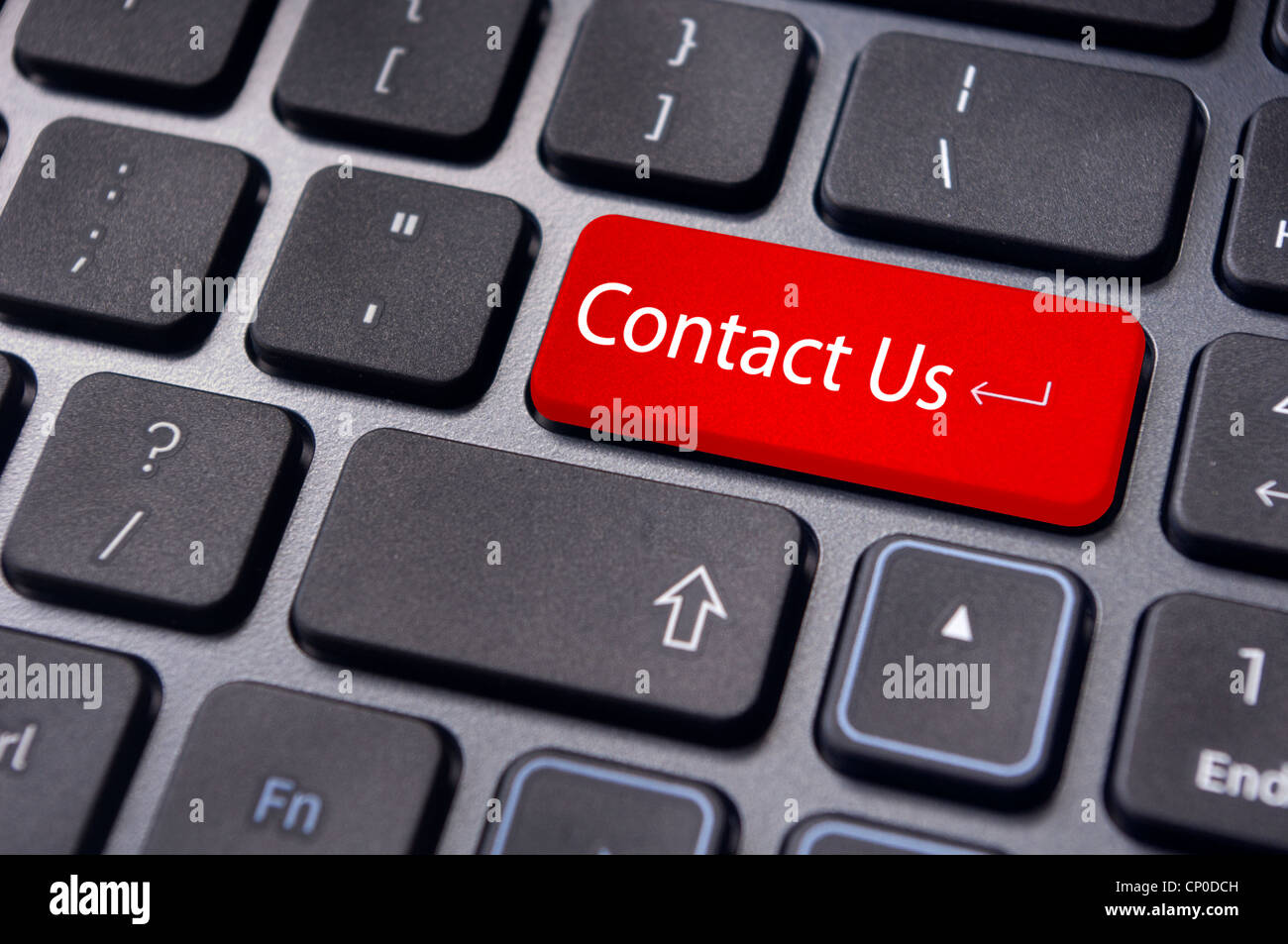 A 'contact us' message on enter key of keyboard, for online communications. Stock Photo