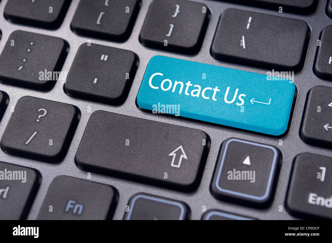 A 'contact us' message on enter key of keyboard, for online communications. Stock Photo
