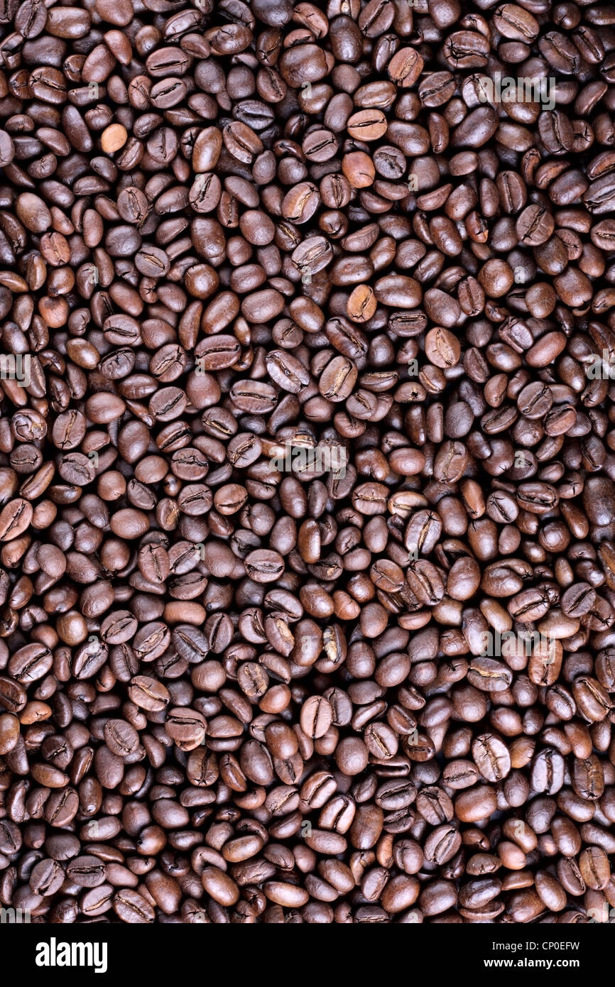 Many brown roasted coffee beans at background Stock Photo - Alamy