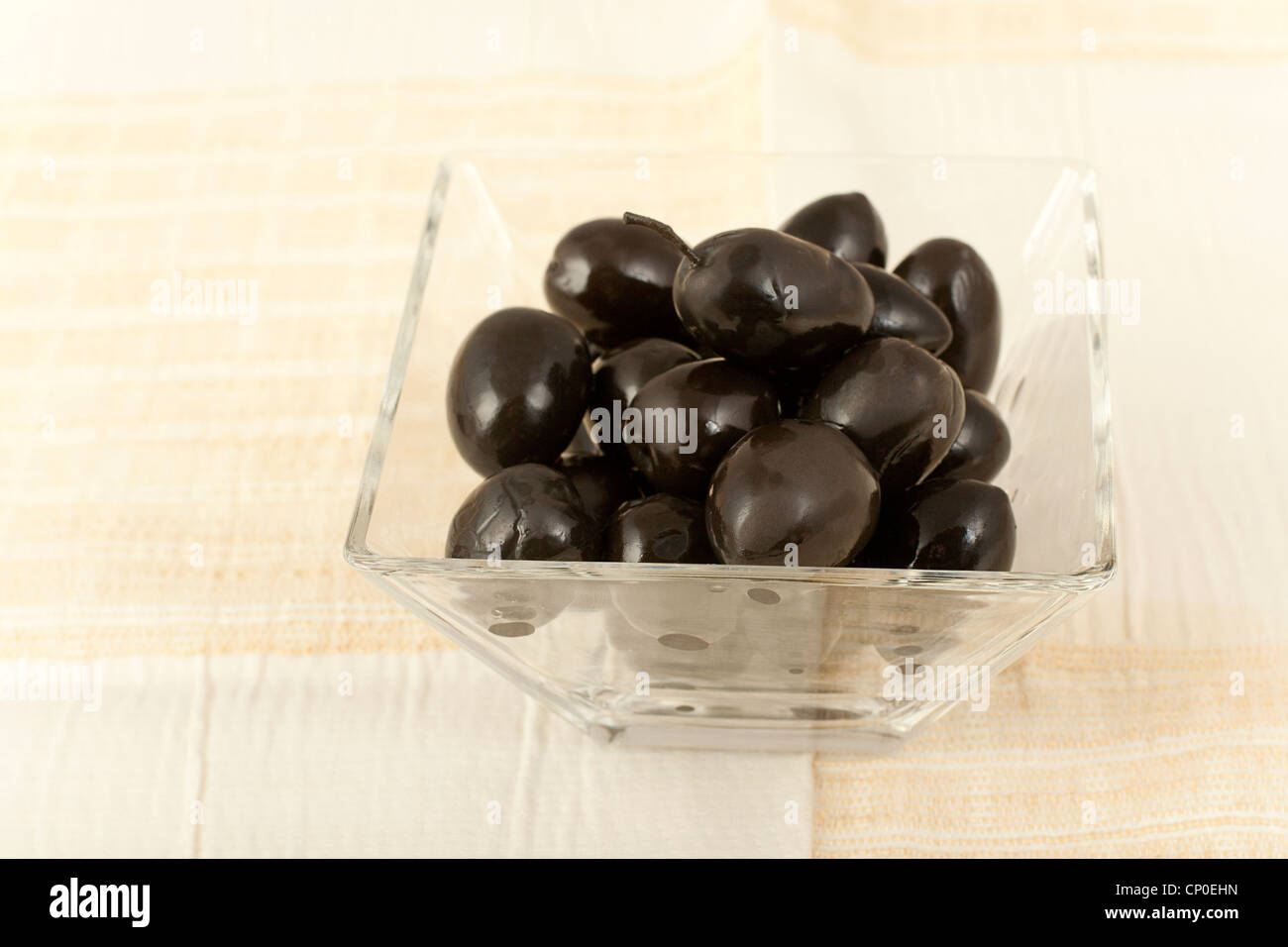 black olives in a glass salad bowl Stock Photo