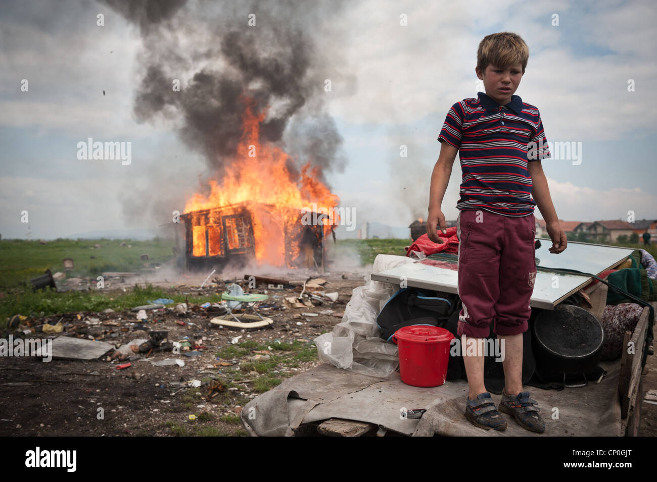 Roma boy waits for authorities to displace his family to new house that authorities made for them in outskirts of Sarajevo. Stock Photo
