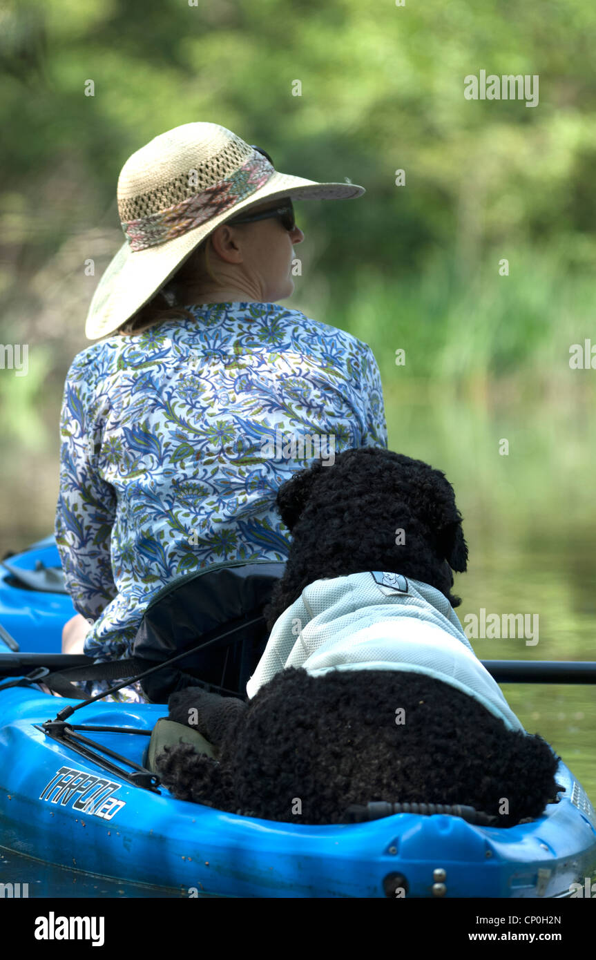 a lady and her dog go kayaking Stock Photo