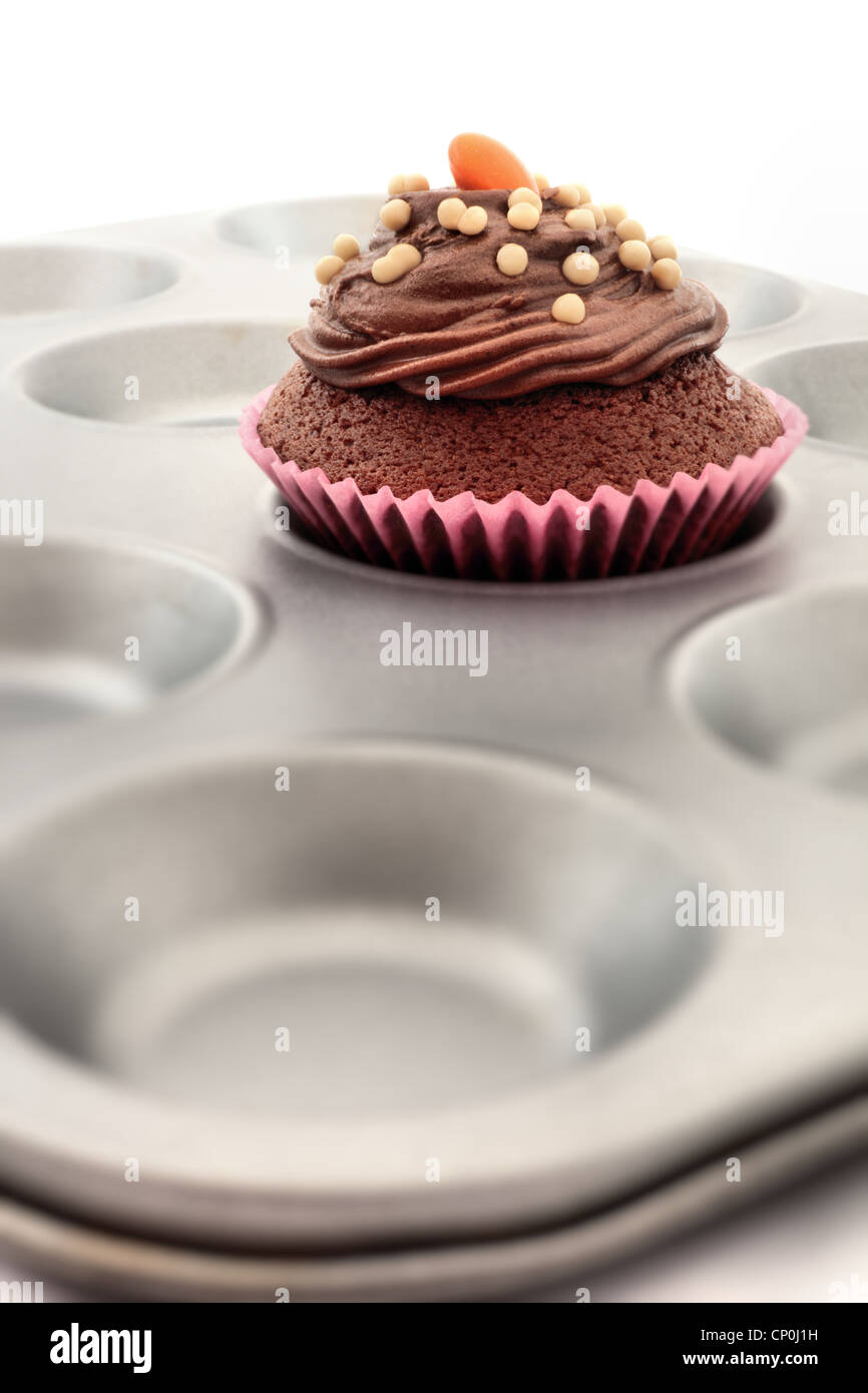 Single cupcake or fairy cake in a baking tray Stock Photo