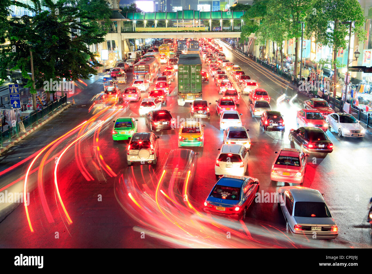 This image was taken in Bangkok (near Central World) at 23:00h. The long-term exposure shows the night traffic. Stock Photo