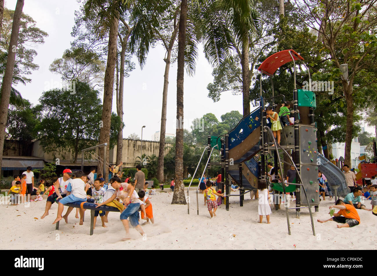 Horizontal wide angle of a busy children's play area in Tao Dan Cultural Park in Ho Chi Minh City. Stock Photo