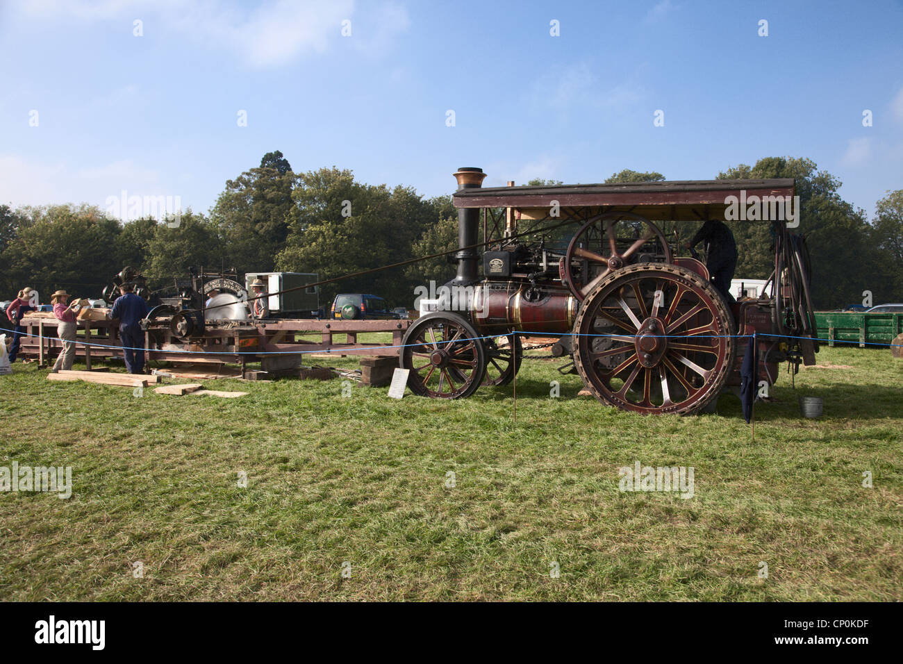 Saw bench driven by steam traction engine Stock Photo