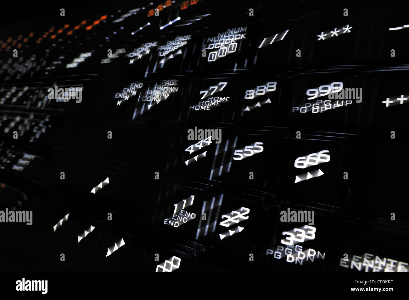 Abstract technology image showing black computer keyboard with illuminated backlit white characters on keys jumping out Stock Photo