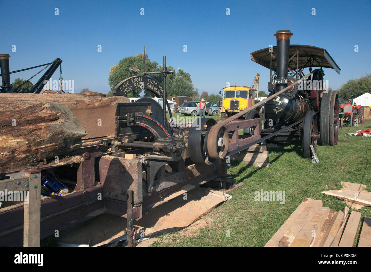 Saw bench driven by steam traction engine Stock Photo