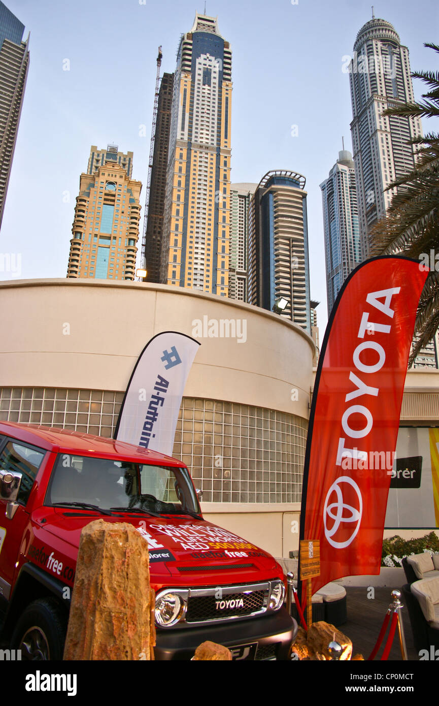 A Toyota jeep on display at Barasti bar in front of skyscrapers, Dubai