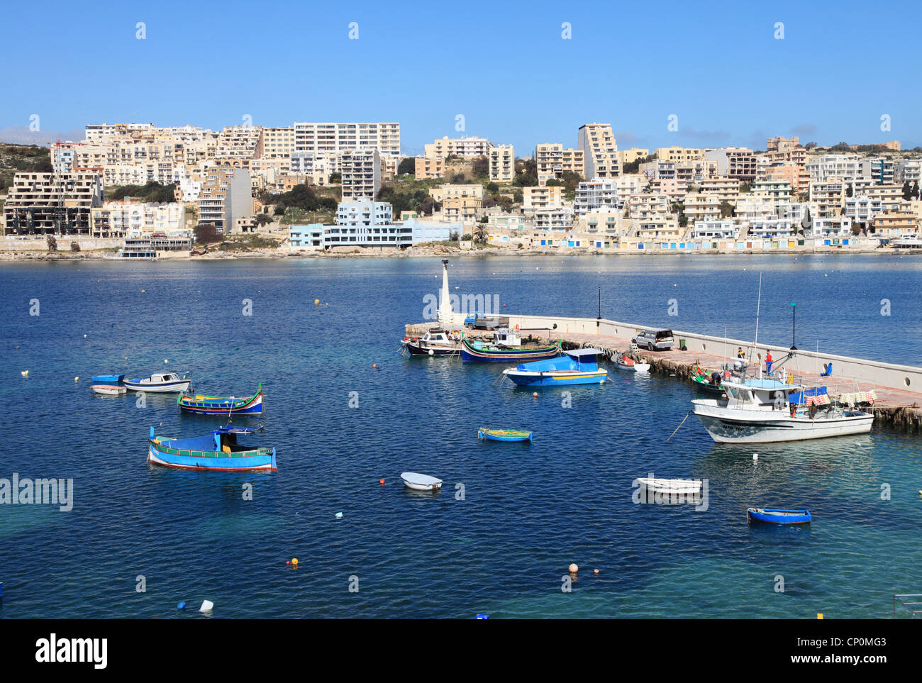 View across St Paul's Bay, Malta, with fishing boats and small harbour in the foreground
