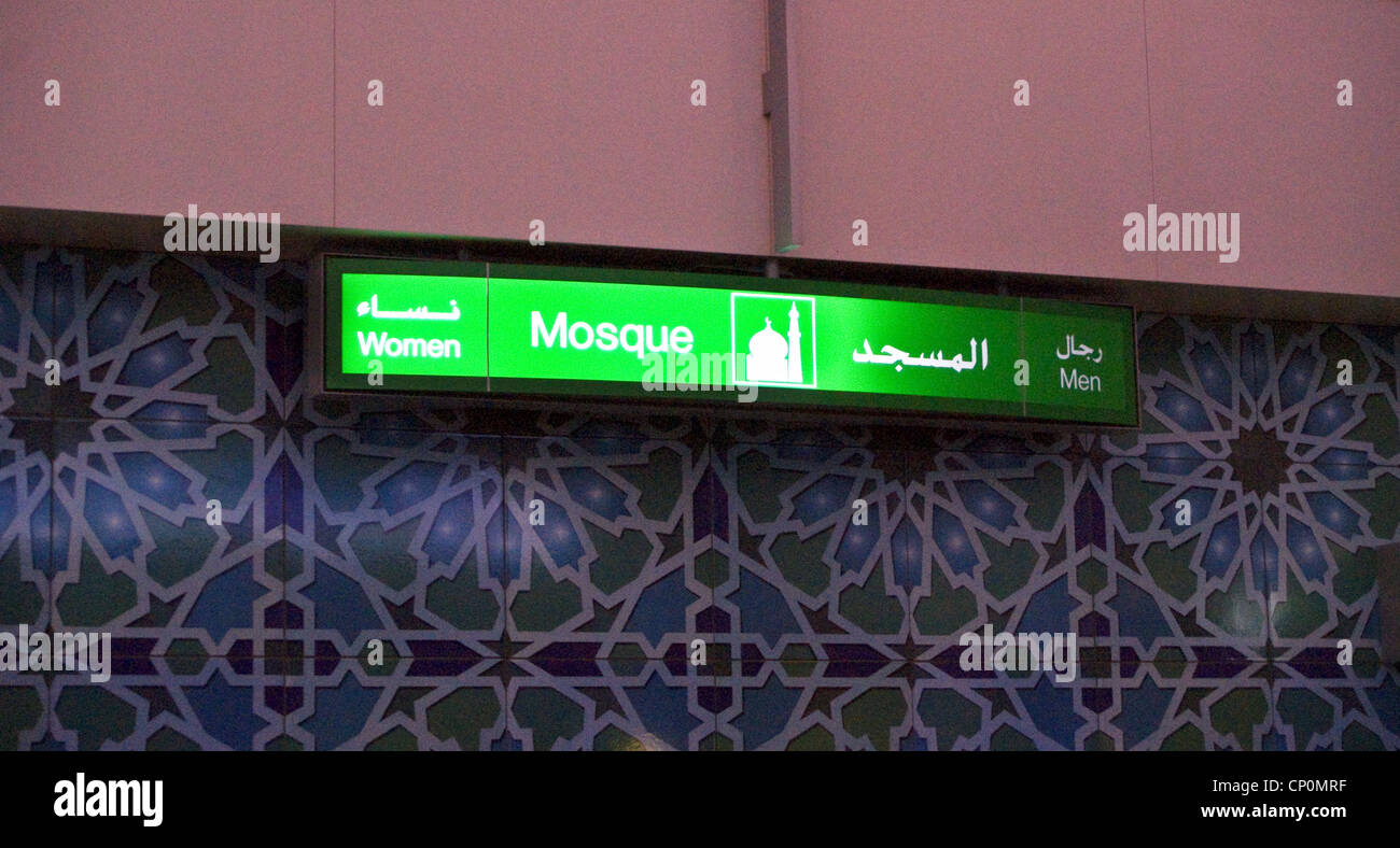 Illuminated sign giving directions to the airport mosque at Dubai