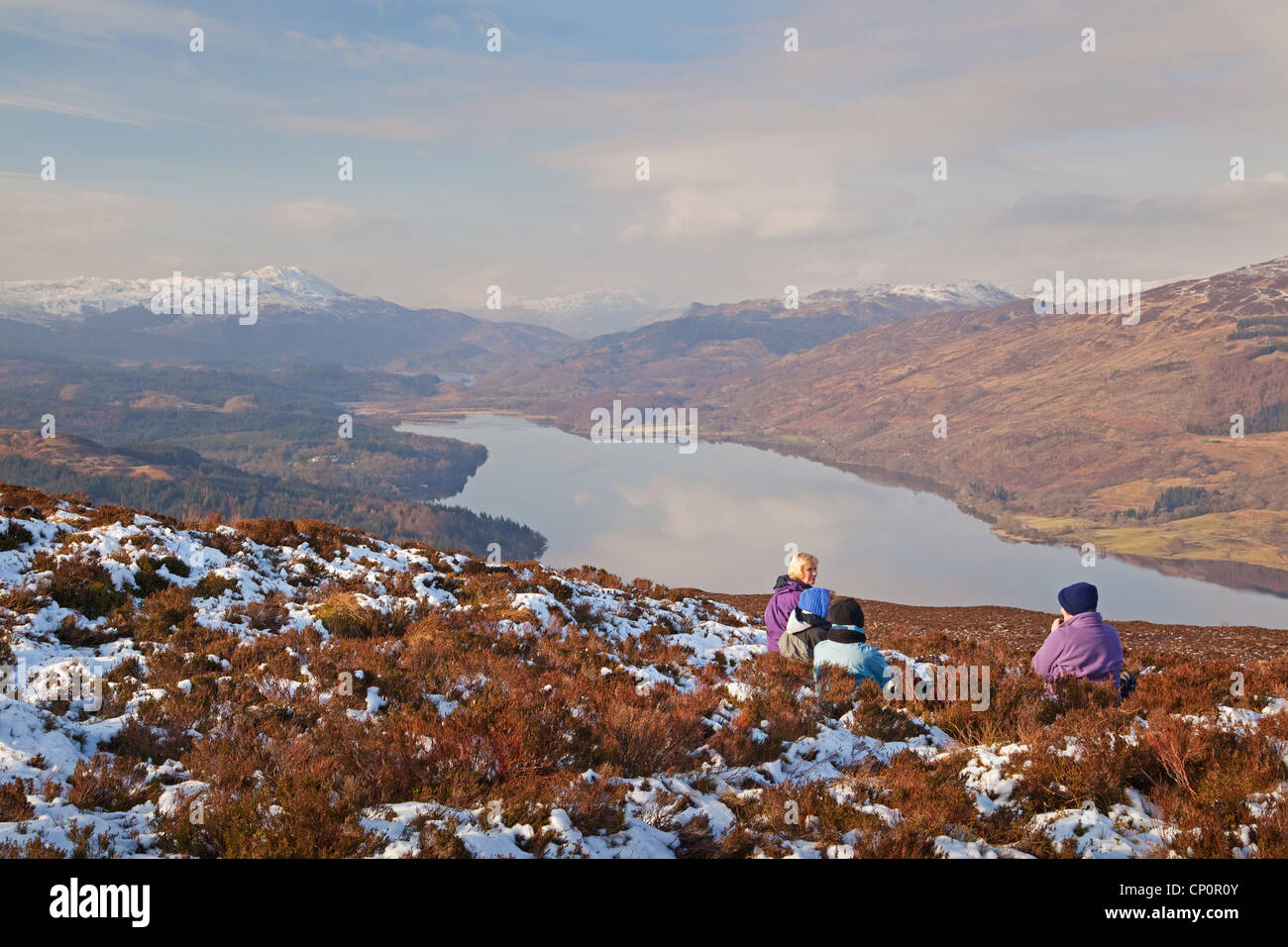 Walkers on Ben Gullipen, looking down Loch Venachar near Callander Stock Photo
