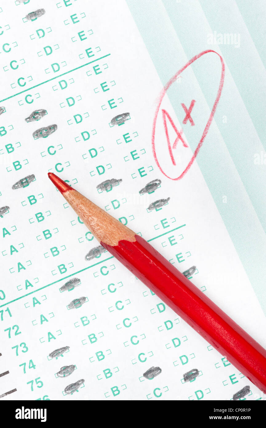 A graded test form with red scoring pencil indicates achievement and success in education. Stock Photo