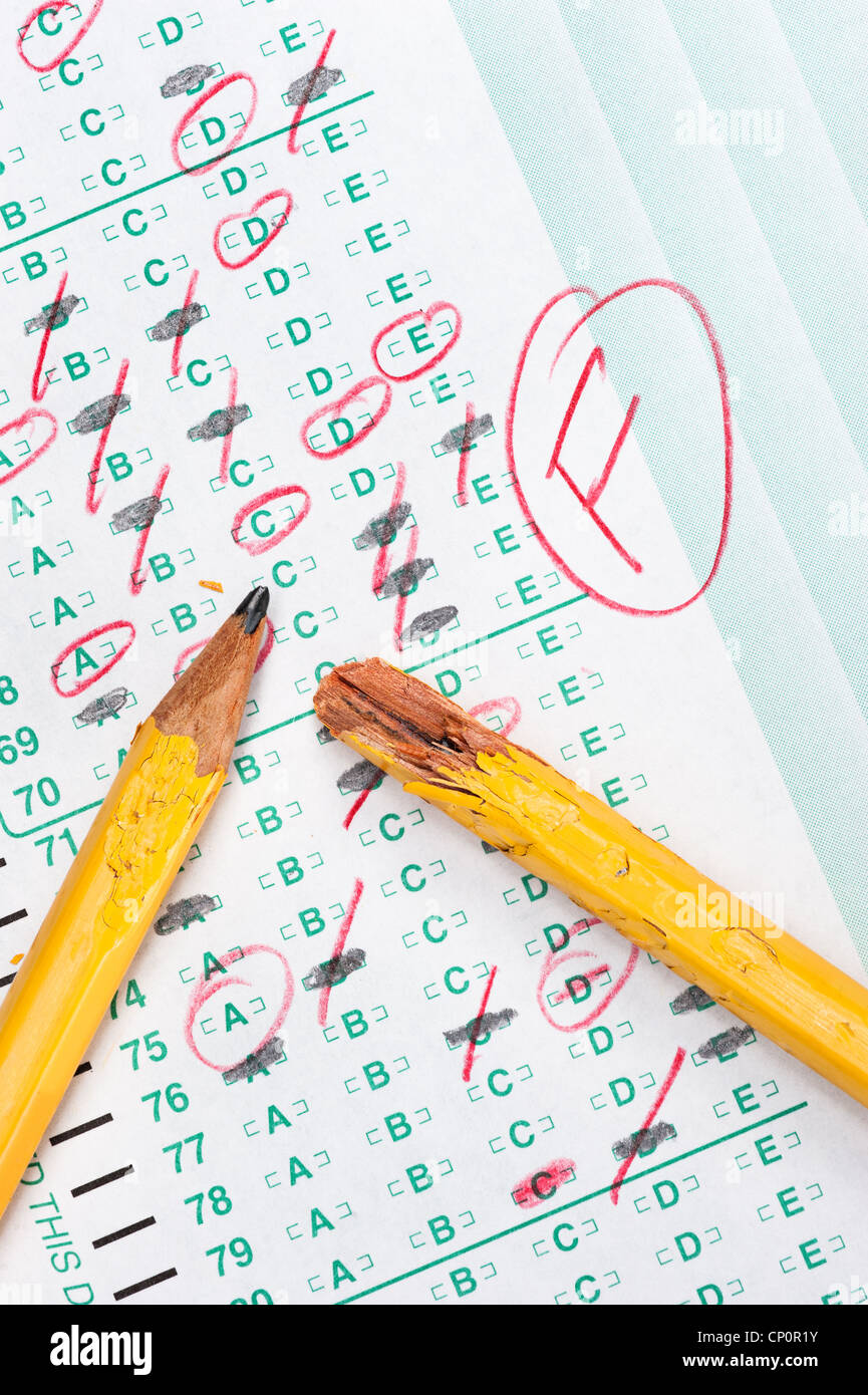 A graded test form with red scoring pencil marks indicates frustration and failure in the education system. Stock Photo