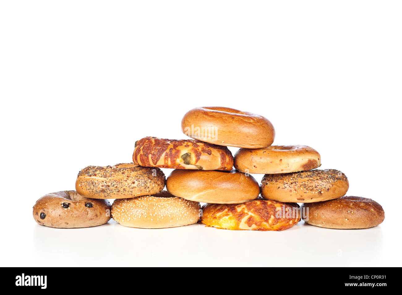 A stack of assorted, fresh, flavorful bagels on a white background Stock Photo