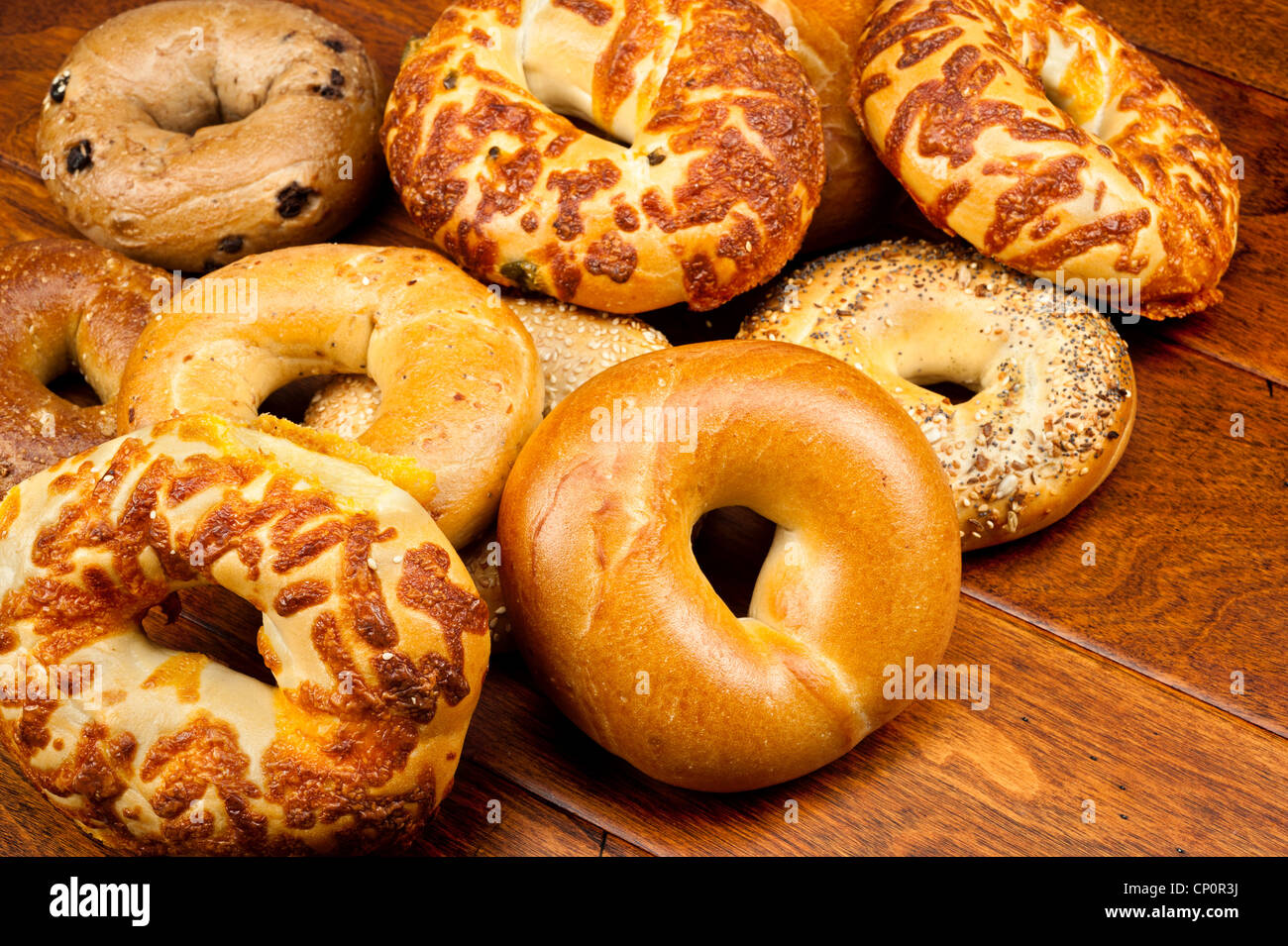 An assortment of fresh bagels on a wooden table Stock Photo