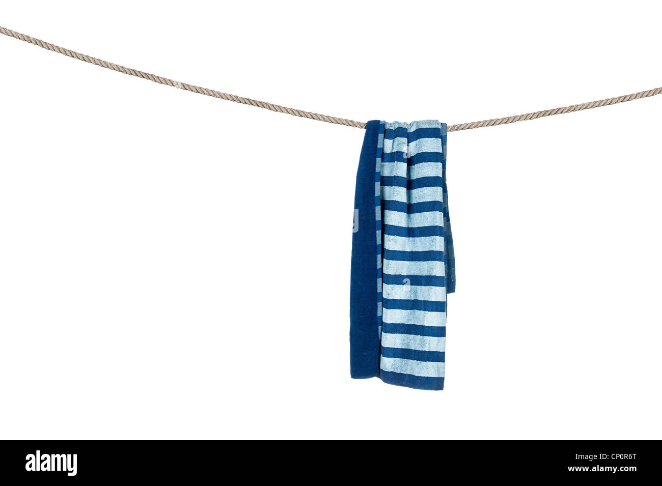 A beach towel hanging on a rope isolated on a white background. Stock Photo