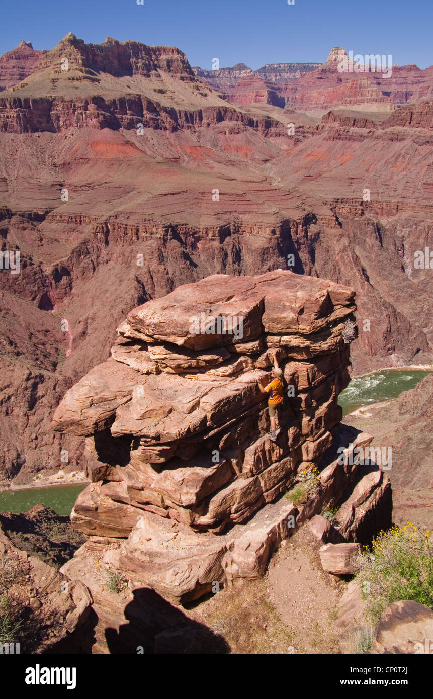 a man climbing up to an overlook at Plateau Point in the Grand Canyon Stock Photo