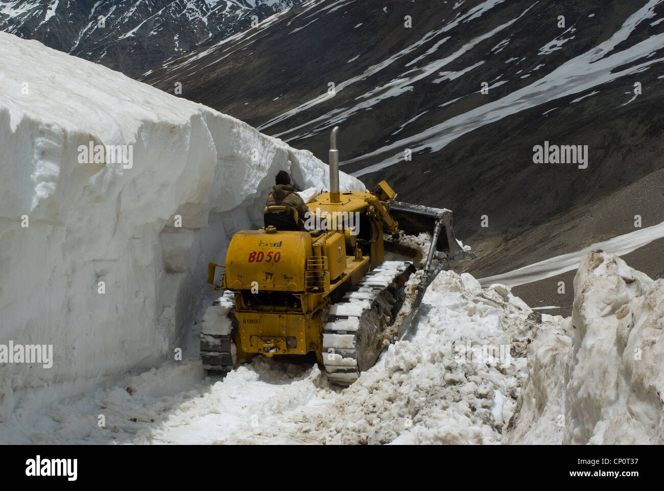 Bulldozer removing snow from the road in Lahaul valley, India Stock Photo
