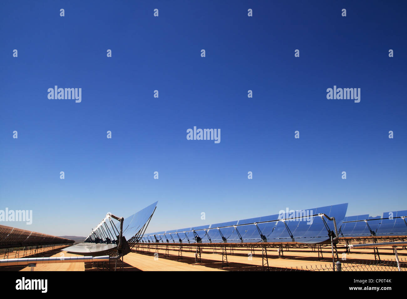 concentrated solar thermal electric energy plant mirrors with blue sky copy space above Stock Photo