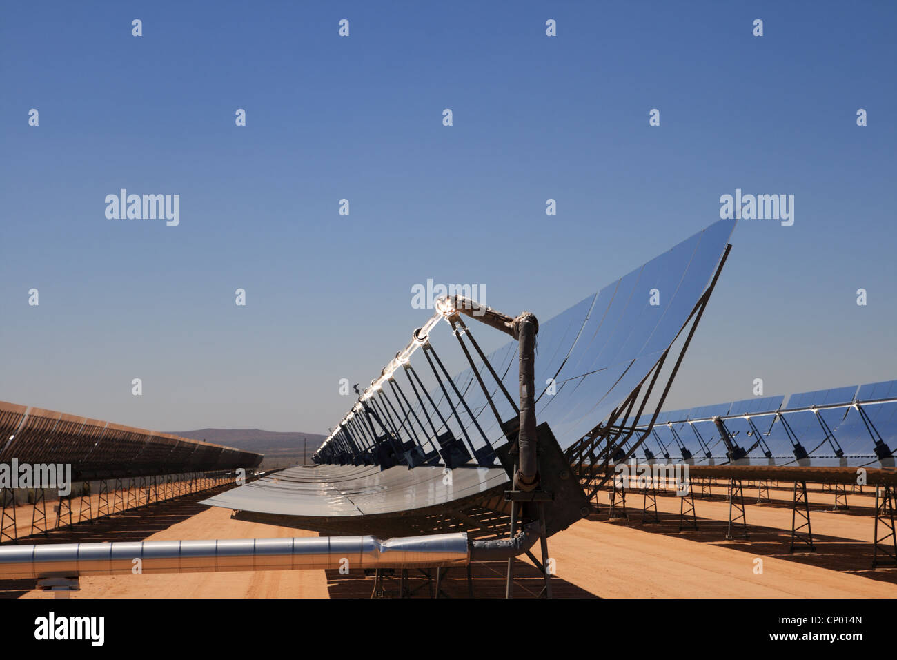 SEGS solar thermal energy desert electricity plant with parabolic mirrors concentrating the sunlight with blue sky copy space Stock Photo