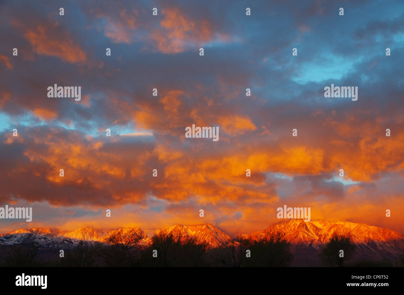 sunrise lights up the clouds and the eastern sierra mountains from Bishop California Stock Photo