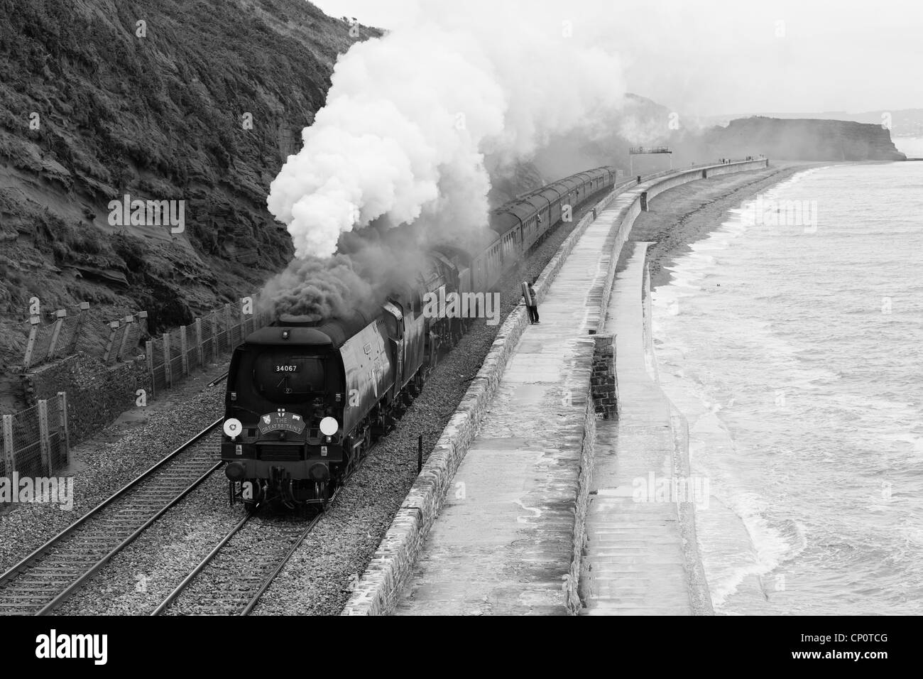 The Great Britain V double headed by 34067 Tangmere and 70013 Oliver Cromwell along the sea wall Dawlish south Devon UK Stock Photo
